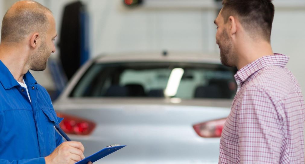 Mechanic and hs customer check the car