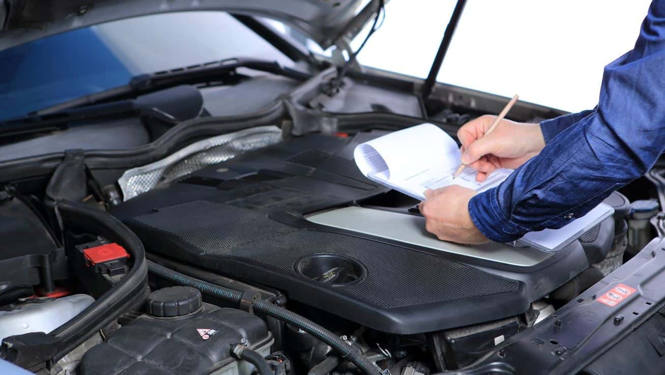 A mechanic check the engine under the hood