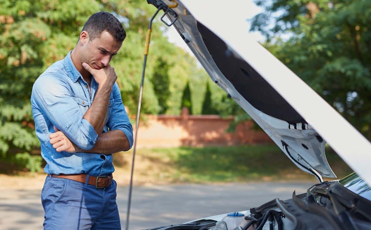 Man checking the engine under the hood