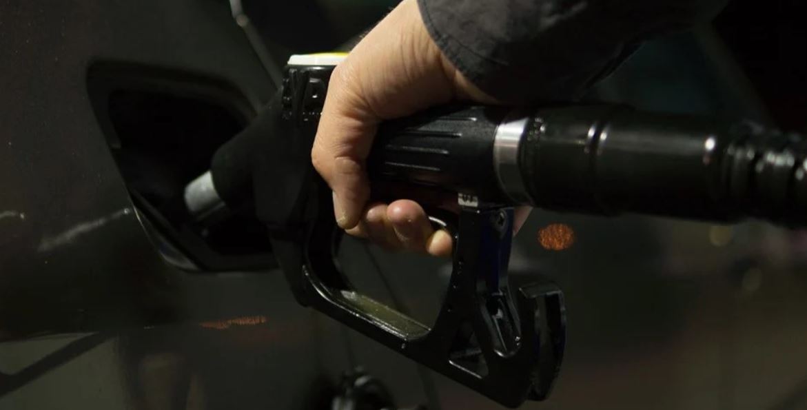 Man filling gas into a car