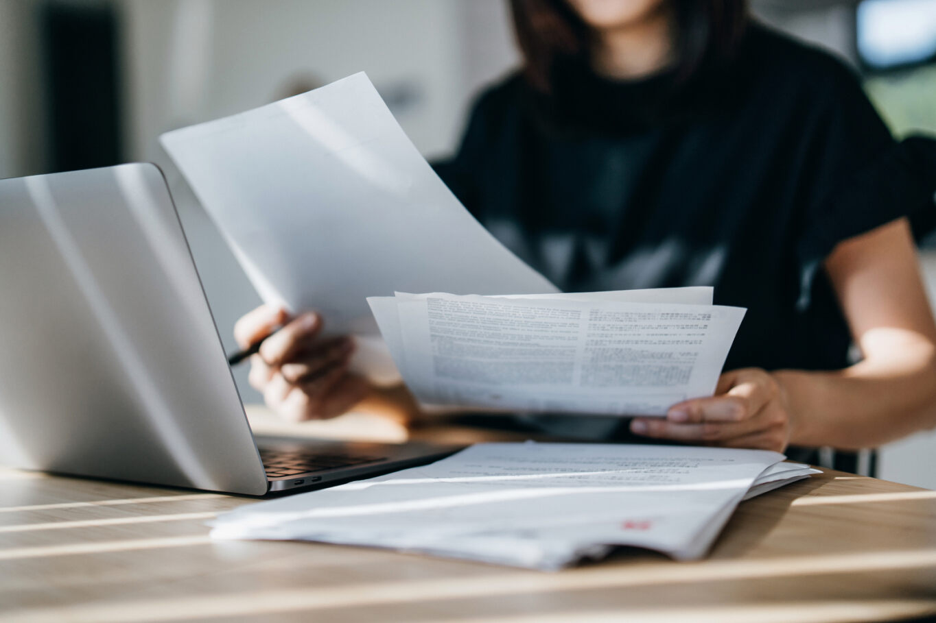 a woman reviewing her monthly insurance bills